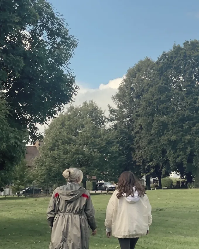 Andrea walking side by side with a client during an outdoor session